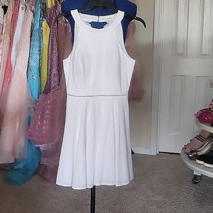 White lace dress, knees high open back.